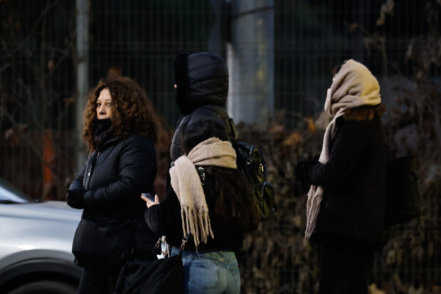 Personas se protegen del frio con temperaturas pronosticadas bajo cero en la comuna de San Bernardo. Foto: Aton Chile.
